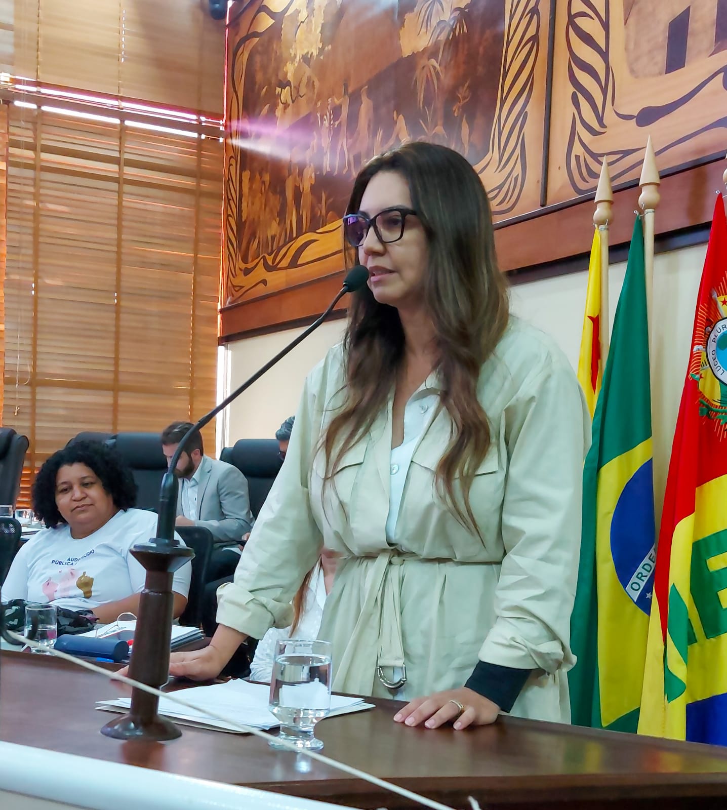 Imagem da juíza Andréa discursando no microfone no púlpito